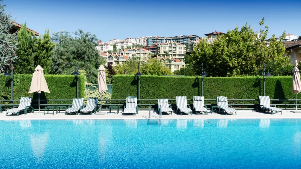 Luxury commercial swimming pool with lounge seating and landscaped surroundings